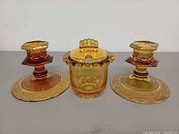 Front view showing both candle holders and sugar container