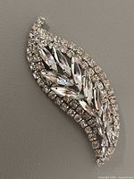 Front view of Sherman clear rhinestone leaf brooch