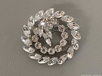 front view of rhinestone wreath brooch