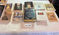 Ten books laid flat on table, full front covers visible