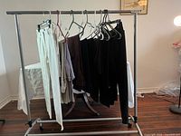 Rack showing all 13 pairs of petite pants in assorted colours