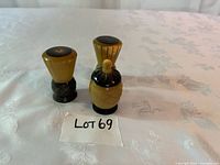 Full view of two shakers and toothpick holder