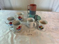 Group shot showing all ceramic and plastic mugs with lids