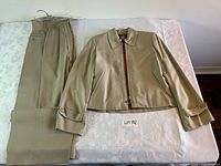 Jacket front and trousers folded displayed on table