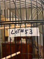 Close-up of cage bars and lot label