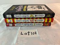 Spines of three Diary of a Wimpy Kid hardcovers stacked