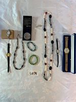 Group shot of all items including watches, necklaces, bracelets, brooches