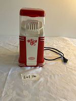 Front view of popcorn maker showing branding and power cord