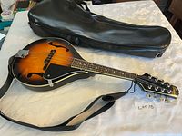 Full view of mandolin with strap and gig bag