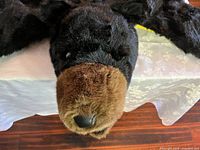 Close-up of bear head showing black faux fur and brown snout