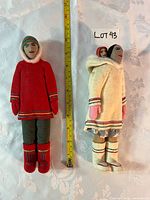 Full view of both dolls with tape measure for scale