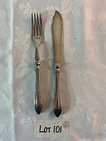 Knife and fork pair on tablecloth