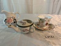 Group shot of milk jug, feeding cup, teacup and saucer