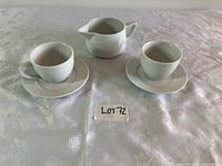 Full set showing two cups, two saucers, creamer