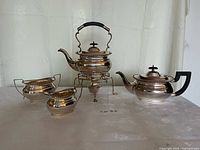 Full view of all four silver-plated pieces on table