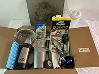 Open box showing full assortment of kitchen items and book