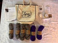 Lot overview showing tote, six skeins, felted soap, pamphlet