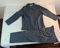 Full view of jacket and pants laid flat