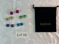 Complete set with earring frames, five pairs of stones, pouch visible