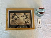 overview of framed print, teacup with saucer, and sealed pen