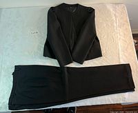 Full view of jacket and pants laid flat