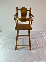 full front view of wooden baby seat