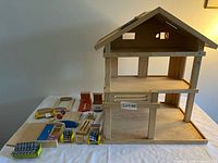 Overall view of dollhouse with furniture laid out