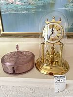 Clock and covered dish side by side for scale and full view