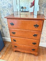 Front view of four-drawer dresser showing hardware and finish