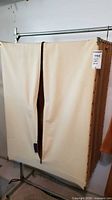 Full view of wardrobe with cover closed showing zippered front