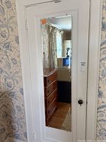 Full view of frameless mirror mounted on door