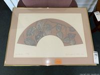 Entire framed print on chair, showing artwork, mat and frame