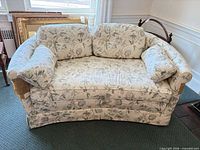 Front view of floral loveseat with cushions