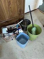Lot overview showing bins, wastebasket, duster, box of assorted items