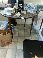 round dining table with items on top (contents excluded)