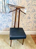 Front view of valet stand showing seat, hanger, brush on tray