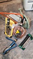 Assorted garden and hand tools with watering can, hacksaws, air pump, pots