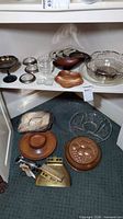 Overview of mixed wood, glass and metal serveware on shelves