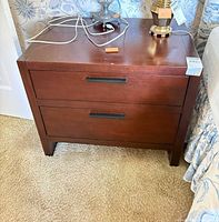front view of nightstand closed showing dark cherry finish and two drawers