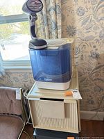 Humidifier on top of storage cabinet with lamp visible