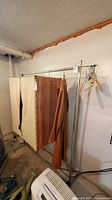 Overall view of garment rack with garments for scale