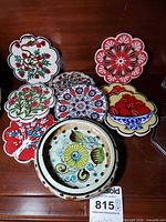 Front view showing bowl and eight coasters with varied floral designs