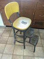 Overall view of Cosco step stool showing seat, backrest, frame and steps