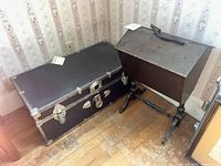 Steamer trunk and sewing box on stand side by side