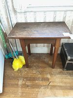 Front view of solid wood side table against wall