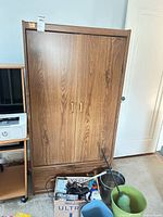 Front view of brown oak laminate wardrobe with double doors and lower drawer
