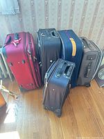 Five suitcases lined up showing relative sizes and colors