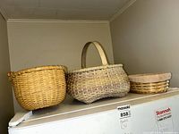 Three baskets on appliance: round, oval with handle, shallow with liner