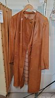 Front view of leather coat on hanger