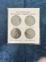 Front view of sealed holder with four coins and titled insert